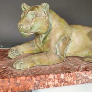 Lionne allongée Art Déco en régule à patine verte, sur un socle en marbre 49cm